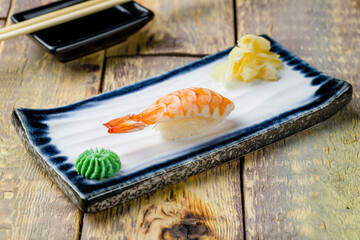 sushi with shrimp on wooden table side view