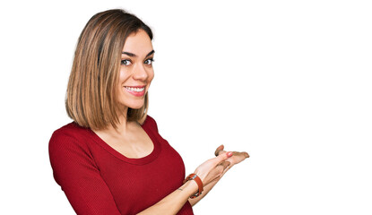 Young blonde girl wearing casual clothes inviting to enter smiling natural with open hand