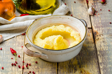 mashed potatoes on bowl on wooden table