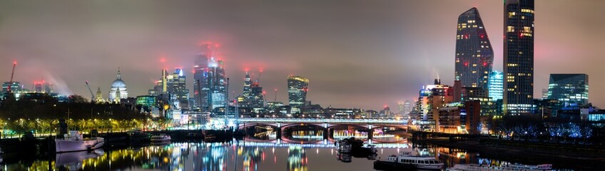 Skyline panorama Southbank of river Thames at night in London. England