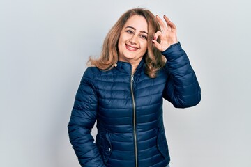 Middle age caucasian woman wearing casual clothes smiling positive doing ok sign with hand and fingers. successful expression.