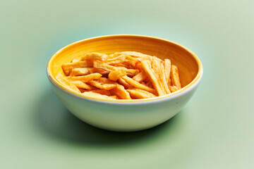  Bowl of french fried potatoes over green background