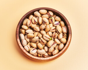  Bowl of pistachios over yellow background