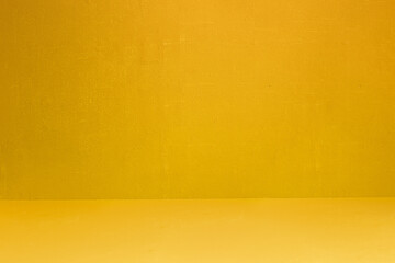 Yellow textured wall and floor with some small white spots and dirt. Artistic painted background. Abstract art with copy space.