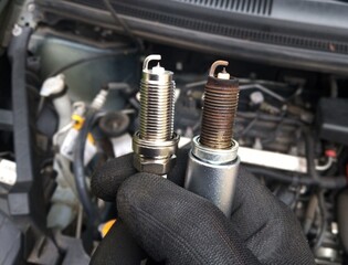 changing of spark plugs - maintenance and repair work at a car