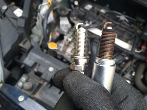 changing of spark plugs - maintenance and repair work at a car