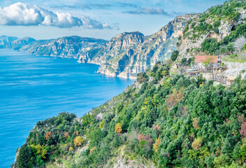 Fototapeta na wymiar View of the Sorrentine Peninsula and Capri along the Amalfi Coast of Italy, with Tyrhennian Sea under blue skies and clouds
