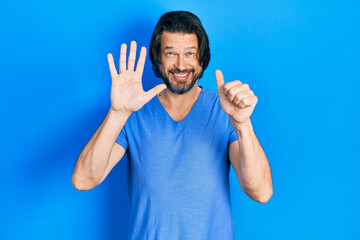 Middle age caucasian man wearing casual clothes showing and pointing up with fingers number six...