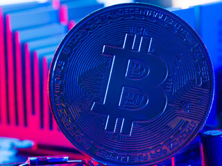Macro shot of the popular bitcoin cryptocurrency on the desktop of the processor of a personal computer, laptop. New technologies, engineering, cryptocurrency mining, crypto farms, communications.
