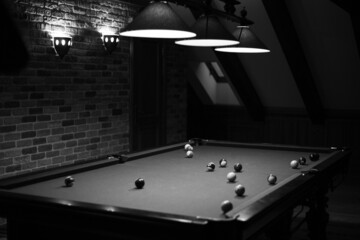 Billiard table in the billiard room with balls and cue