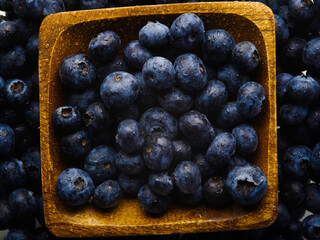 Close-up. Fresh blueberries in a yellow bowl. High angle view. There are no people in the photo. Cooking, healthy eating, vitamins, antioxidants, ingredients for cooking.