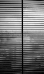 Metal blinds on windows in rainy weather