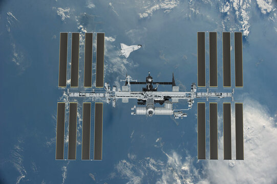 International space station on orbit of the Earth planet. View from outer space.ISS. Earth with clouds and blue sky. Elements of this image furnished by NASA. 3d rendering.
