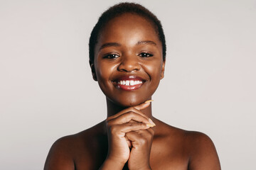 African woman model smiling against white background. Beautiful black woman. Beauty skin female face. Natural beauty.