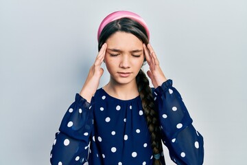 Young brunette girl wearing elegant look with hand on head for pain in head because stress. suffering migraine.