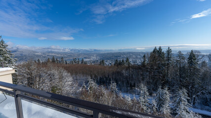 Scenic winter view of Fraser Valley and Burrard Inlet, BC, with alpine mountains in background.