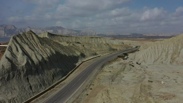 Aerial View Of Empty Highway Road Through Rugged Balochistan Desert Landscape. Dolly Forward