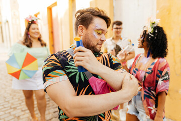 Care during Carnival. Man using sunscreen during carnival block