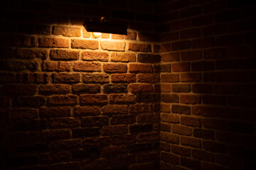 Brick wall illuminated by warm light from a lamp