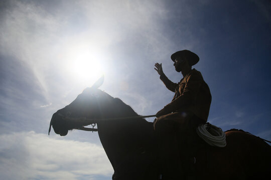 conde, bahia, brasil - january 8, 2022: Cowboy wearing traditional leather clothes with his horse on a farm in the city of Conde.