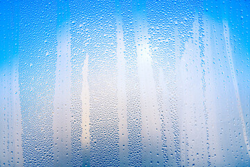 Blue background with water drops . Wet surface with condensation 