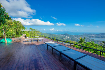 Fototapeta premium Panoramic nature background (mountains, sea, trees, twilight lights in the sky, waterfront communities), naturally blurred through the wind, seen on tourist spots or scenic spots