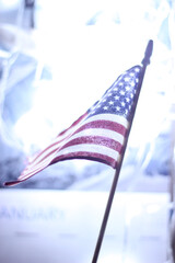 American flag with white light blur background.