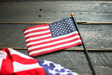 American flag on a black wooden floor illuminated from behind.