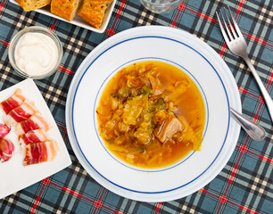 National dish of Russian cuisine is cabbage soup, cooked in thick broth and on the basis of...
