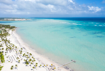 Juanillo beach with palm trees, white sand and turquoise caribbean sea. Cap Cana is a tourist area...
