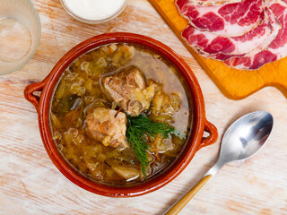 National dish of Russian cuisine is cabbage soup, cooked in thick broth and on the basis of...