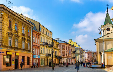 Fototapeta premium View of traditional colored tenements houses on central streets of Polish city of Lublin in sunny spring day