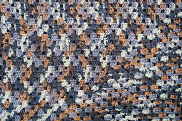 Motley dark rough wool material background texture.