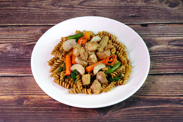 Fusilli, Thai spicy fusion pasta. Thai - Italian fusion Fusilli with chicken, basil leaves and spicy herbs and spices