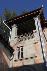 old building historical architectural facade in the city with an arch in the window