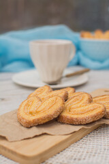 Heart shaped cookies on a wooden stand and a cup of coffee for breakfast.