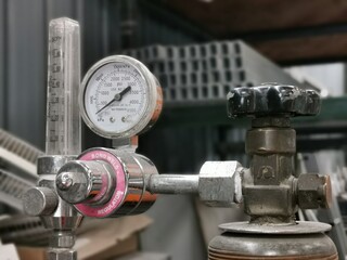 Pressure gauge regulator manometer with blurry background.