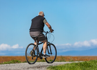 Senior man on cycle ride in countryside in Canada