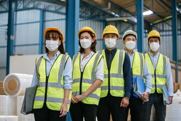 Teamwork engineering in uniform wear hardhat and protection mask at workshop industrial factory. worker professional manufacturing.