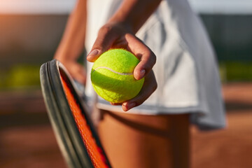 Crop woman playing tennis on court