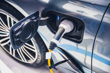 charging EV car electric vehicle clean energy for driving future - obrazy, fototapety, plakaty