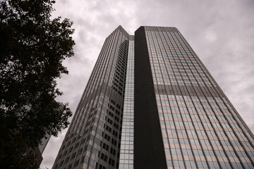 Financial district of Europe in Frankfurt, Germany. Tall skyscraper office buildings photographed in a cloudy day. Business and finance industries.