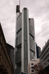 Fototapeta na wymiar Financial district of Europe in Frankfurt, Germany. Tall skyscraper office buildings photographed in a cloudy day. Business and finance industries.