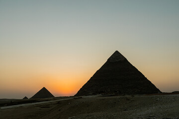 Gentle sunset over the Pyramids of Giza in Egypt