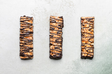 Tasty chocolate nut bars on grunge background