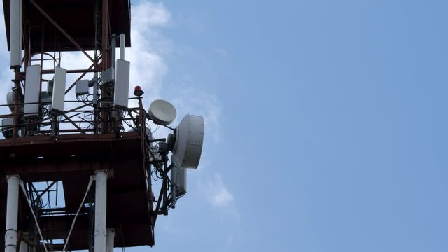 Cell tower carrying antenna of cellular networks. Telecommunication tower with microwave link and transmitter antennas. GSM mast. 5G or 6th generation network concept