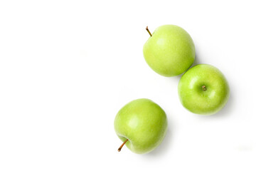 Flat lay of fresh green apples isolated on white background.