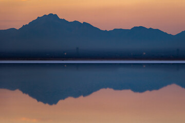 Orange sky and blue mountains and salt lake