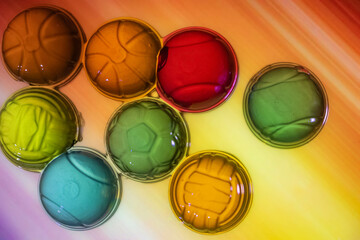 Different shapes of jelly on the colored surface