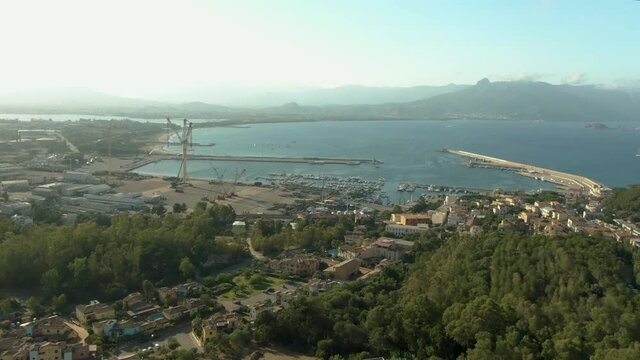 Aerial footage of arbatax east coas Of Sardinia Italy, harbor with luxury yacht and sail boat moored at harbor